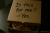 A pizza box turned into a quiet power move — handwritten “Is this for me — Yes.”